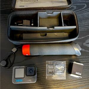 GoPro Black Camera with Red Accent and Accessories